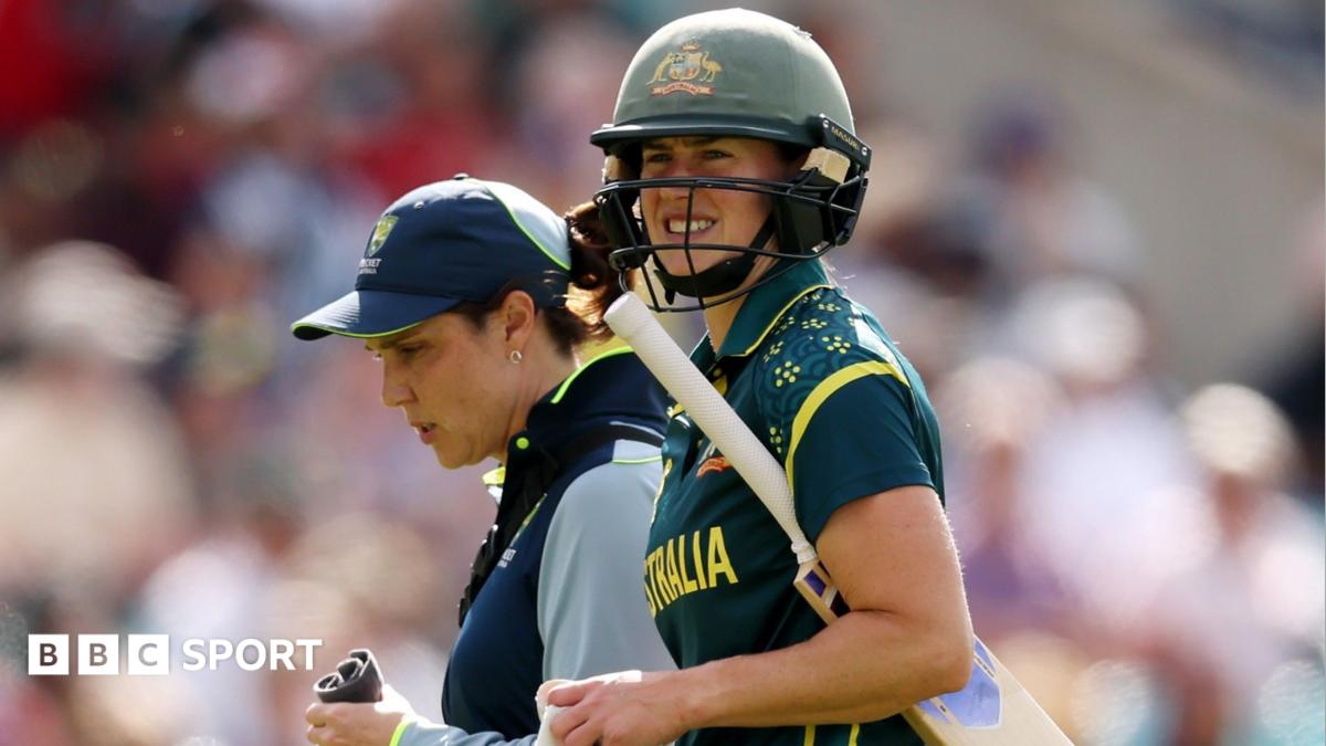 Ellyse Perry grimaces as she walks off the field with the bat under her arm