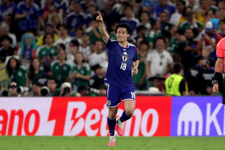 Japan's forward #18 Ayase Ueda celebrates.