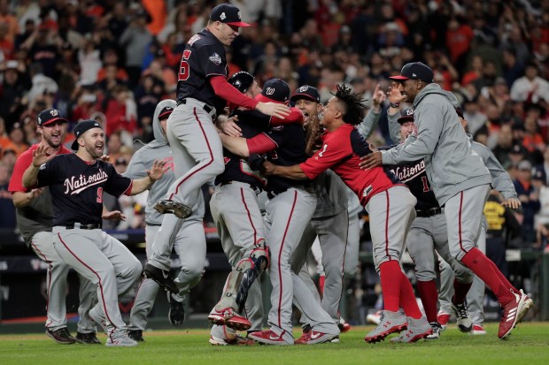 FILE - In this Wednesday, Oct. 30, 2019, file photo, The Washington Nationals celebrate after Game 7 of the baseball World Series against the Houston Astros in Houston. The Nationals won 6-2 to win the series. A year after winning the World Series thanks to a historic turnaround, the Nationals woke up Thursday, Sept. 24, 2020, with a 23-33 record and no mathematical chance of returning to the playoffs. (AP Photo/David J. Phillip, File)