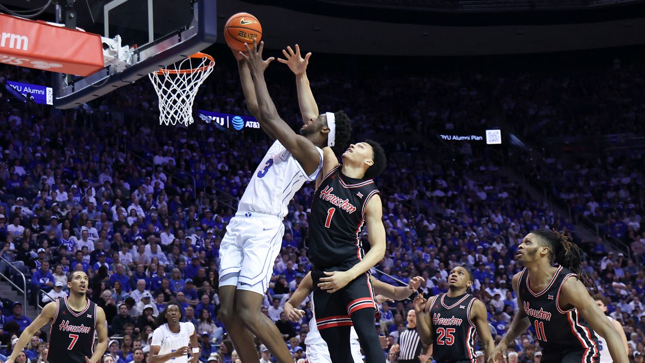 BYU forward AJ Dybantsa (3) goes to the basket against Houston guard Isiah Harwell (1) during an NCAA college basketball game Saturday, Feb. 7, 2026, in Provo, Utah. (AP File Photo/Rob Gray)