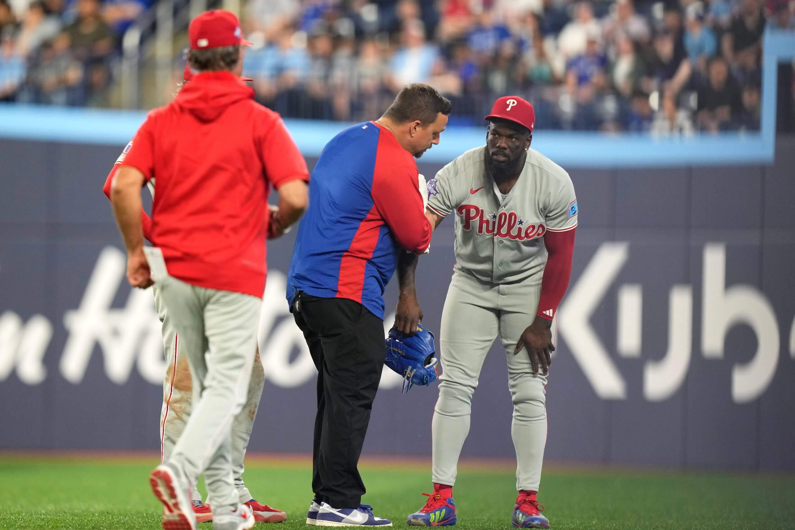 Philadelphia Phillies' Adolis Garcia (53) receives treatment before being helped off the field against Toronto Blue Jays during seventh inning MLB baseball action in Toronto, Ontario, Wednesday, June 10, 2026.