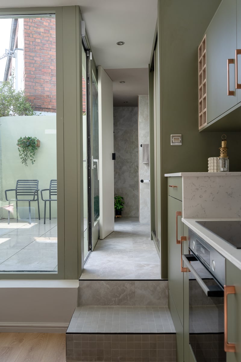 To the rear is a small wetroom/shower and bathroom, along with a utility area. This opens to a small outdoor space through large sliding doors