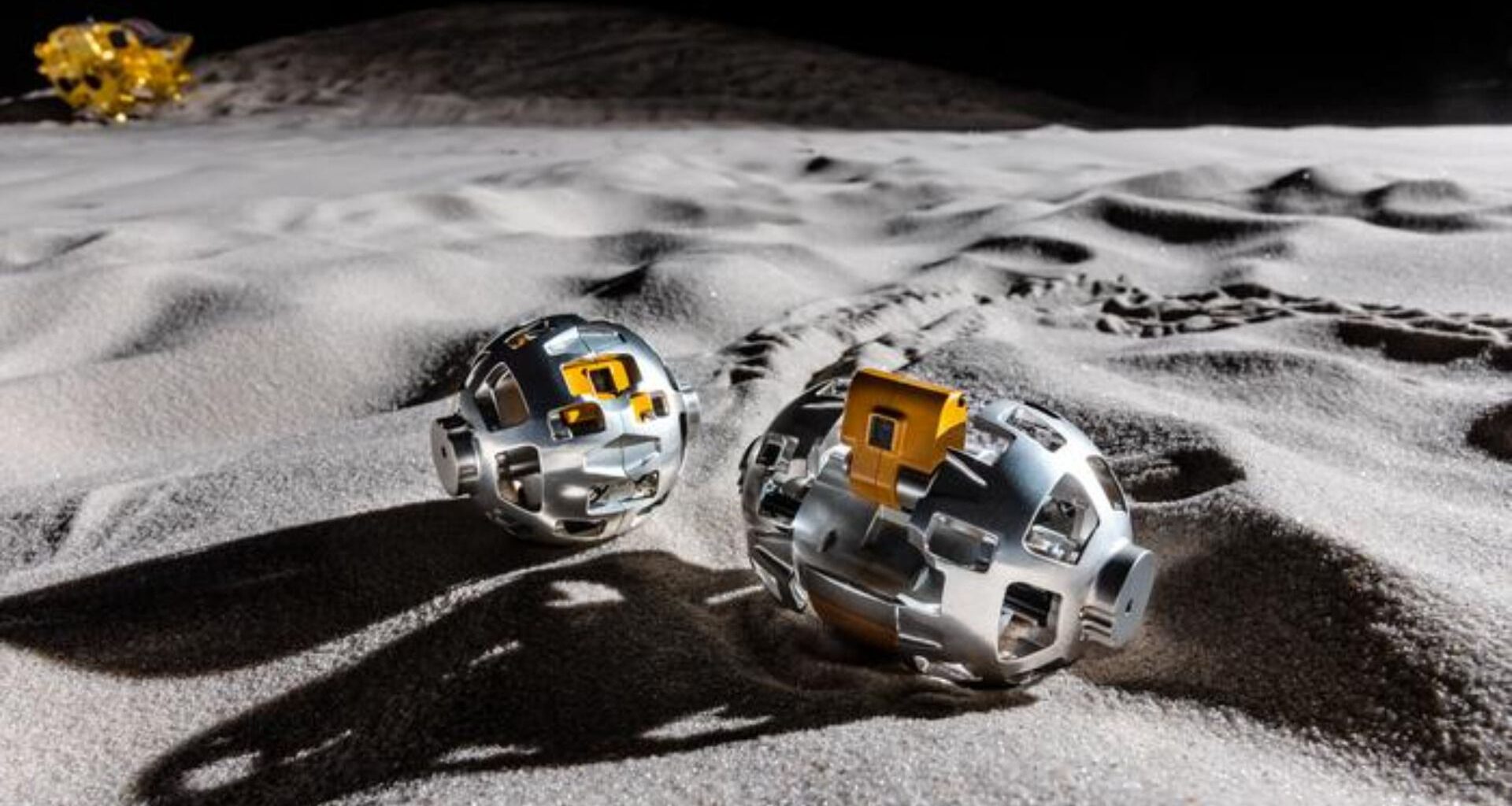 An illustration of two metal rounded objects on the moon's surface.