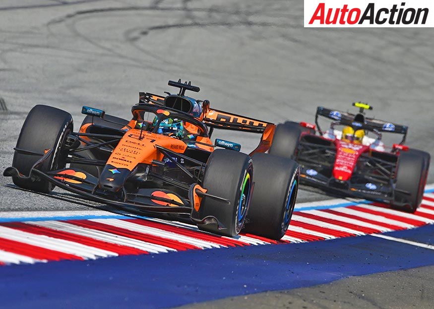 Oscar Piastri leads Lewis Hamilton's Ferrari over a red and white kerb in his orange McLaren during the 2026 Austrian Grand Prix at the Red Bull Ring