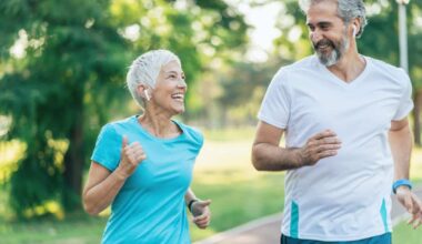 Two people smiling at each other while running.