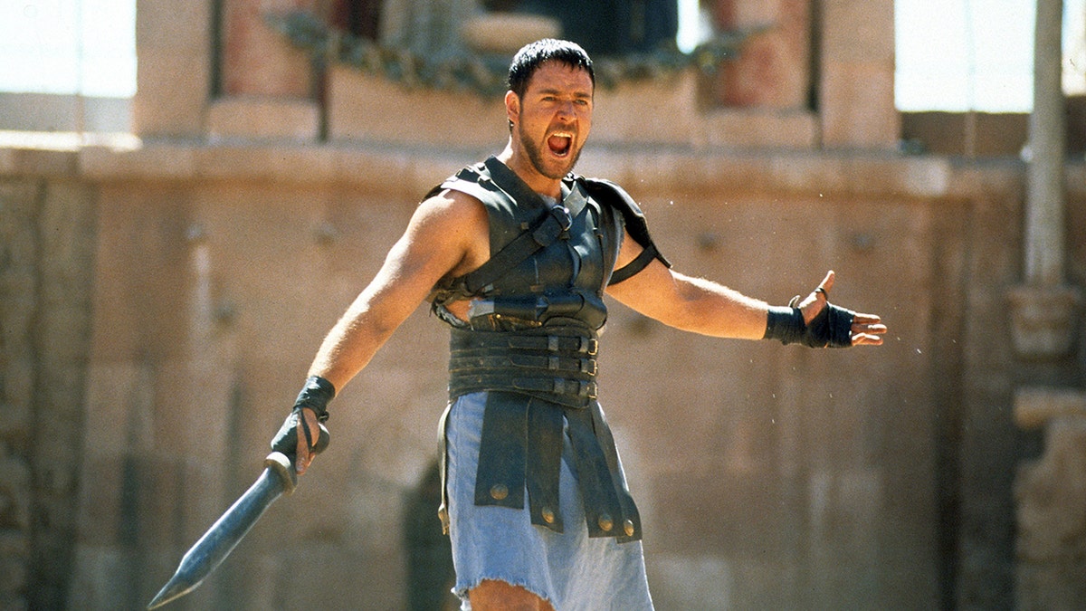 Russell Crowe holding a sword in a scene from the film Gladiator