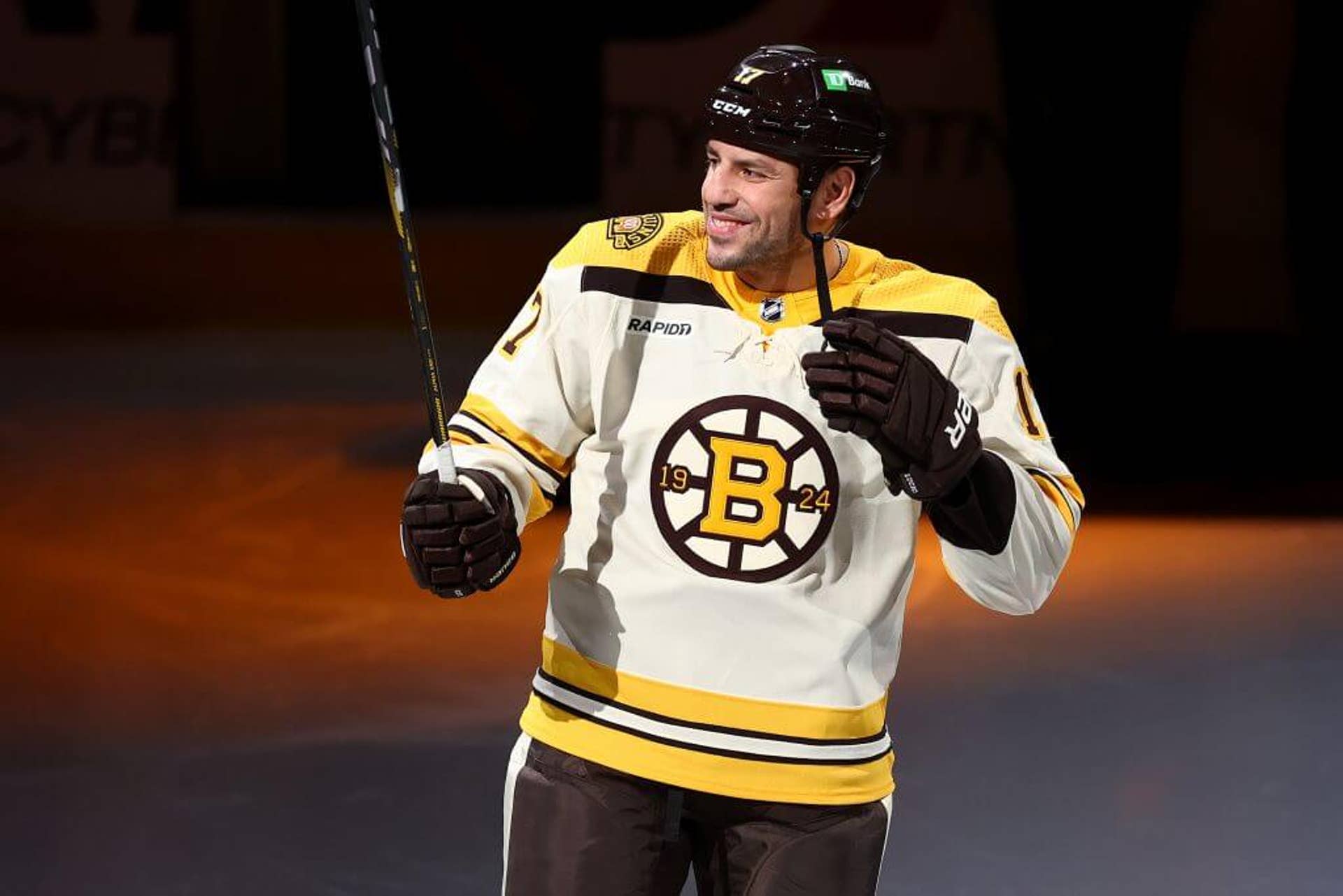 Milan Lucic smiles and waves as he is announced before the Boston Bruins home opener against the Chicago Blackhawks on Oct. 11, 2023.