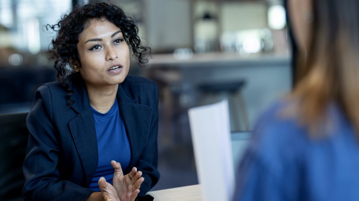 Drive Talent Investments with Strategic Workforce Planning. A female job-seeker answering questions during a job interview with a human resource manager in a business office. - stock photo