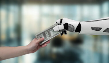 A robotic hand exchanges dollar bills with a human hand,