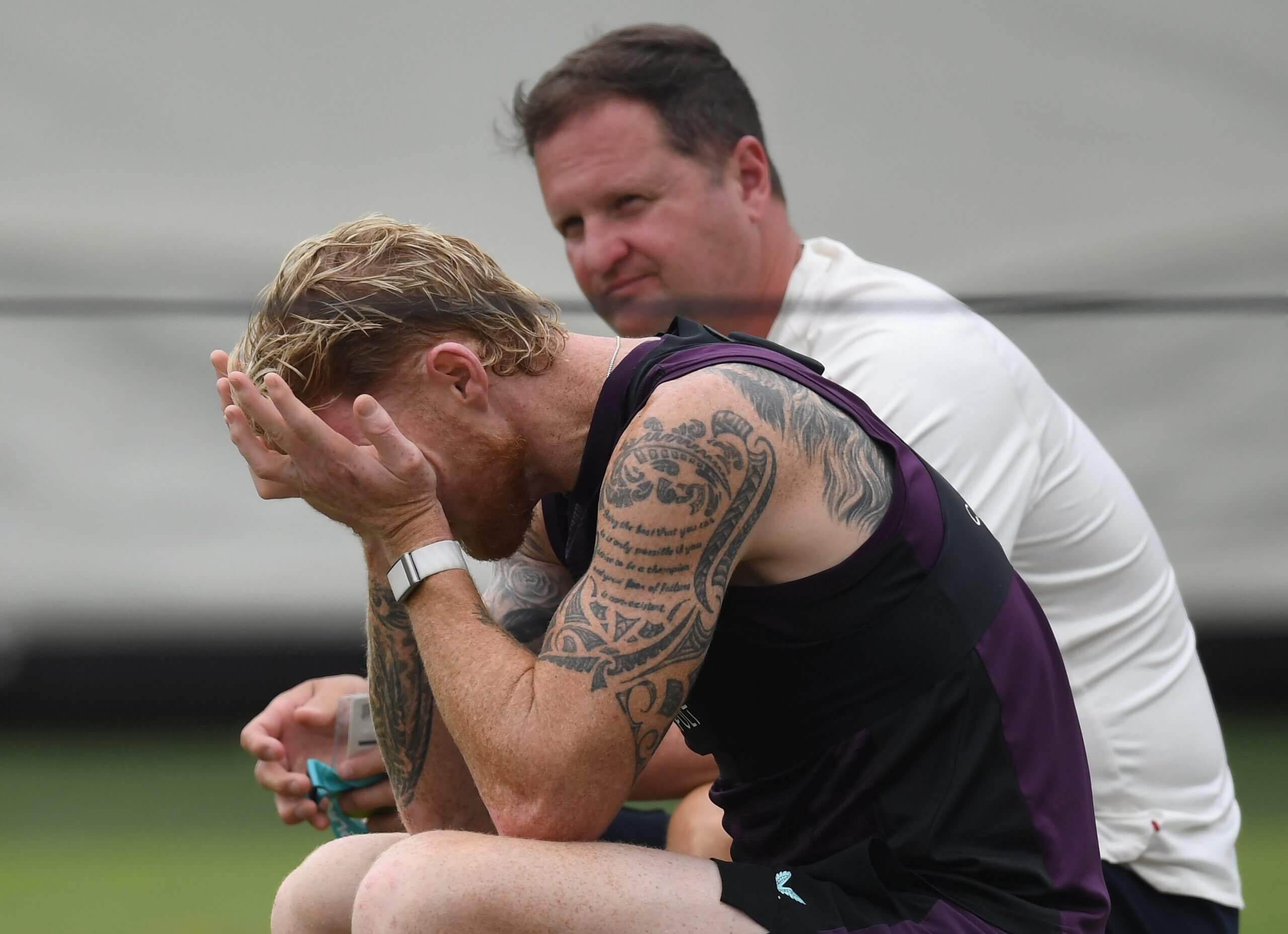 Rob Key and Ben Stokes, with his face in his hands, at an England nets session in Sydney in January