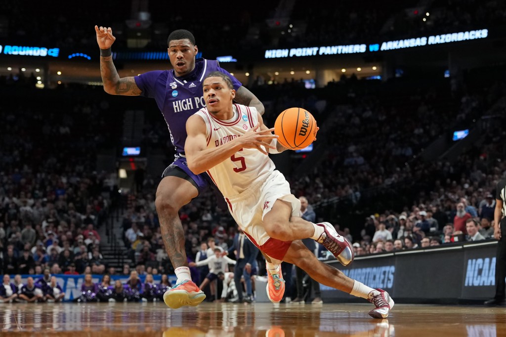 Darius Acuff Jr. #5 of the Arkansas Razorbacks dribbles the ball while being guarded by Cam'Ron Fletcher #11 of the High Point Panthers during the second half in the second round of the 2026 NCAA Men's Basketball Tournament at Moda Center on March 21, 2026 in Portland, Oregon. 