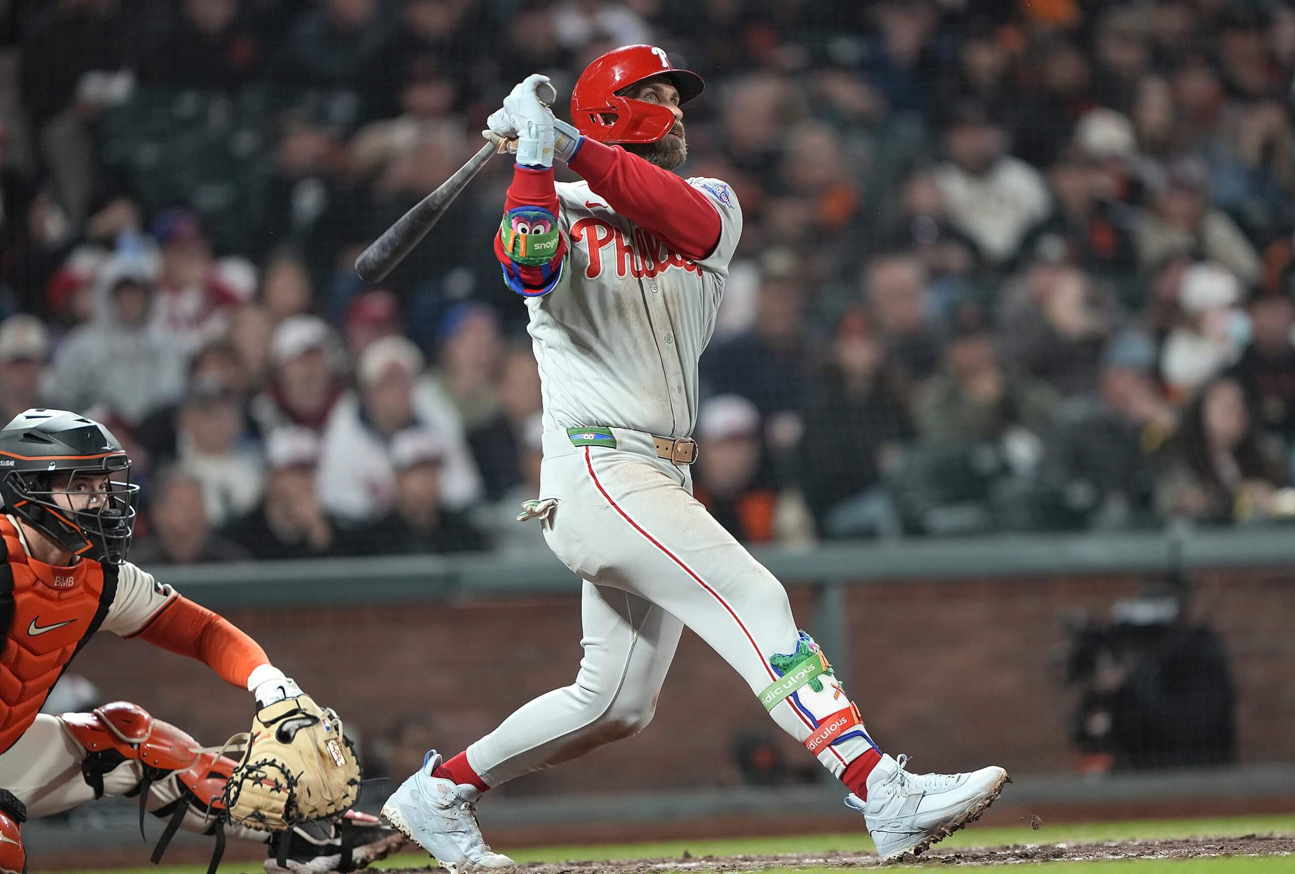 Bryce Harper #3 of the Philadelphia Phillies drives in Justin Crawford with a double in the top of the fifth inning against the San Francisco Giants at Oracle Park on April 06, 2026 in San Francisco, California.