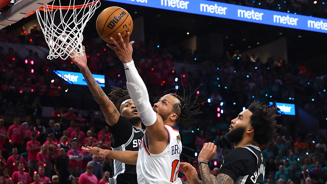 Jalen Brunson #11 of the New York Knicks shoots the ball between Stephon Castle #5 and Julian Champagnie #30 of the San Antonio Spurs during the fourth quarter in Game One of the 2026 NBA Finals at Frost Bank Center on June 03, 2026 in San Antonio, Texas.