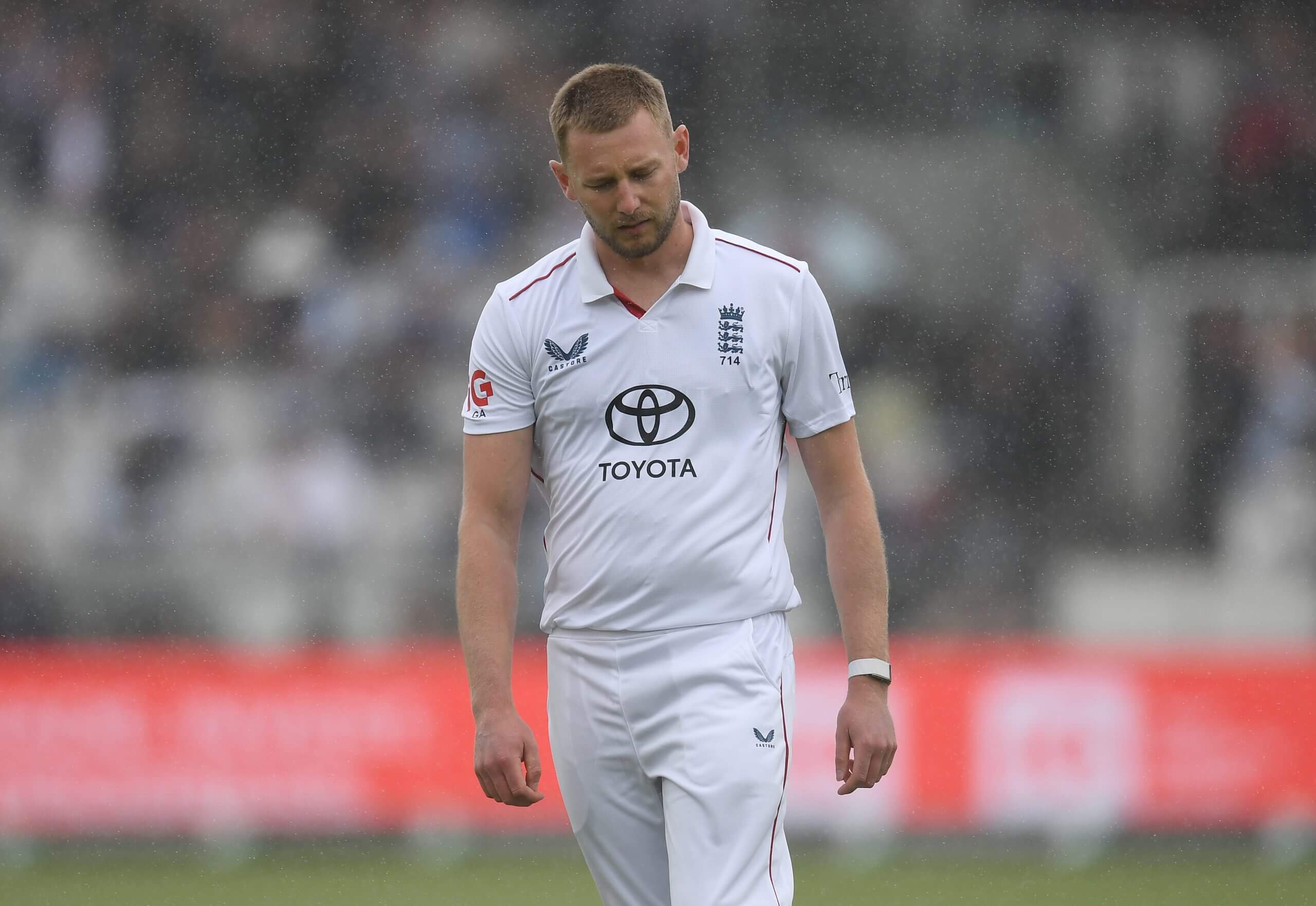 Gus Atkinson cuts a miserable figure in the field as the rain comes down