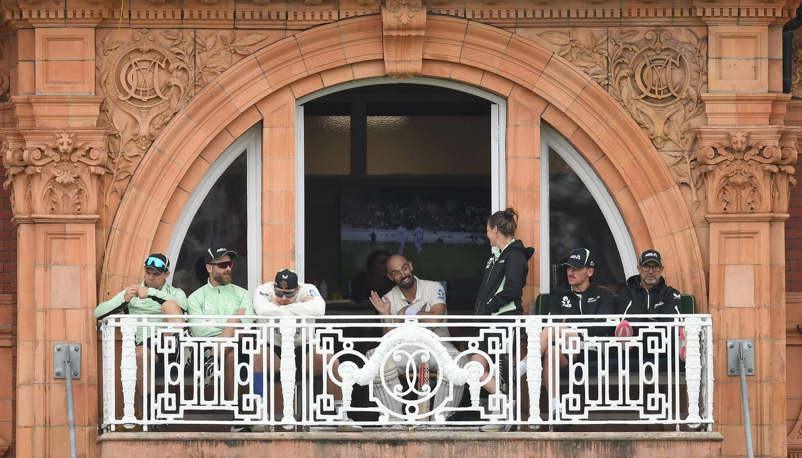 New Zealand's players watch from the dressing-room balcony before the rain comes down again