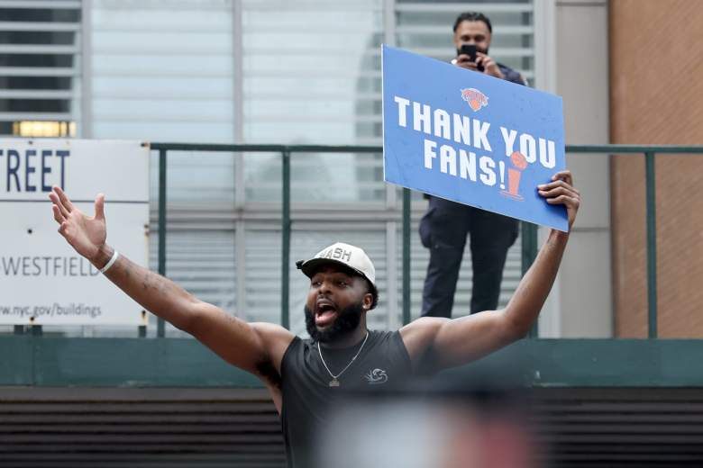 New York Knicks center Mitchell Robinson holds a "Thank You Fans!" sign during the team's championship parade in Manhattan.