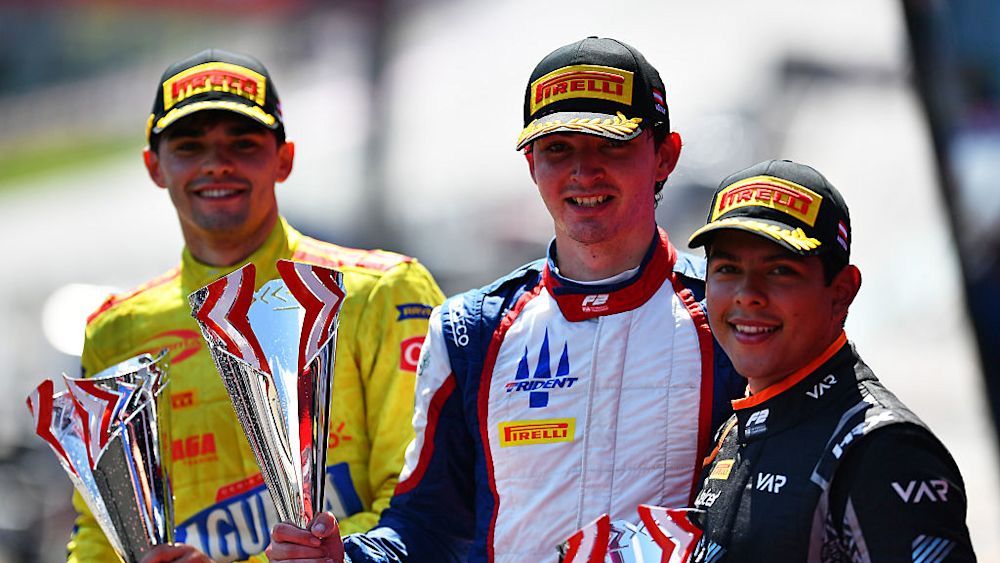 The top three celebrate on the podium at the end of the race