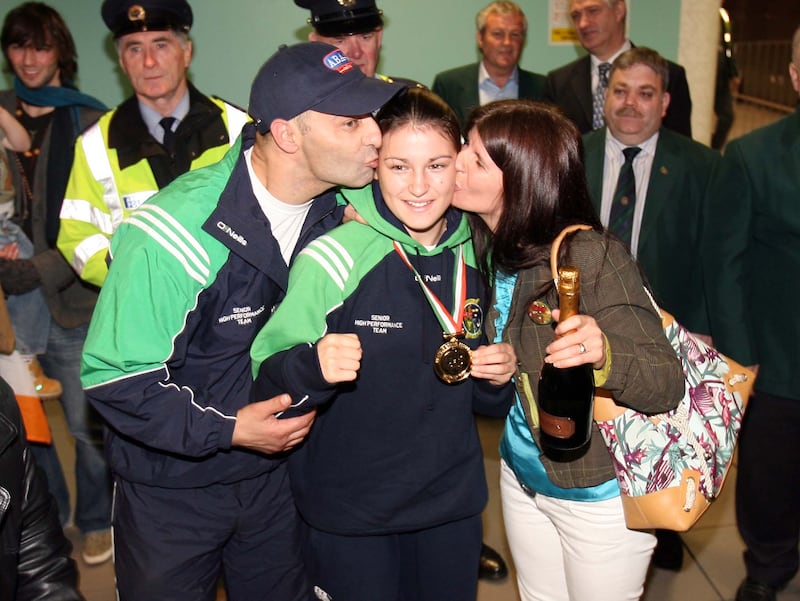 Katie Taylor with her father Pete and mother Bridgette at Dublin Airport with her gold medal from the 2006 European Championships. Photograph: Cathal Noonan/Inpho