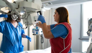 Two healthcare workers preparing a mobile x-ray machine in a hospital room