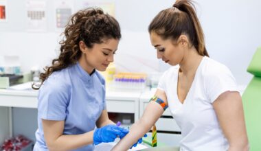 Preparation for blood test with pretty young woman by female doctor medical uniform on the table in white bright room. Nurse pierces the patient