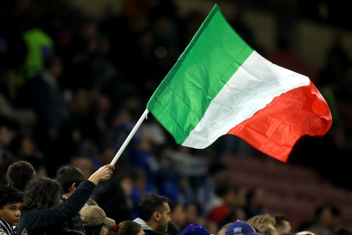 MILAN, ITALY - MARCH 20: An Italian flag is waved by a fan prior to the UEFA Nations League quarterfinal leg one match between Italy and Germany at Stadio San Siro on March 20, 2025 in Milan, Italy. (Photo by Alex Grimm/Getty Images)