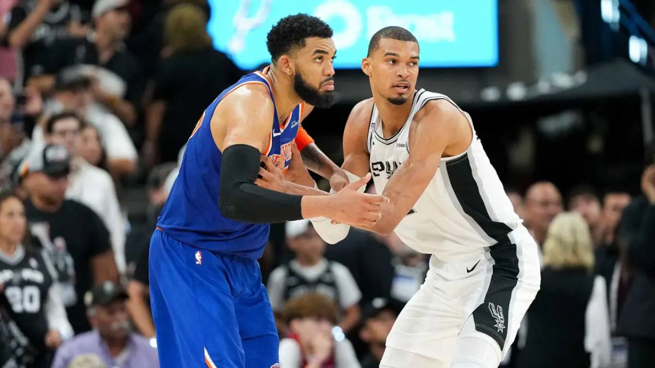 Jun 5, 2026; San Antonio, Texas, USA; New York Knicks center Karl-Anthony Towns (32) and San Antonio Spurs forward Victor Wembanyama (1) look for the ball in the second half during game two of the 2026 NBA Finals at Frost Bank Center. Mandatory Credit: Scott Wachter-Imagn Images