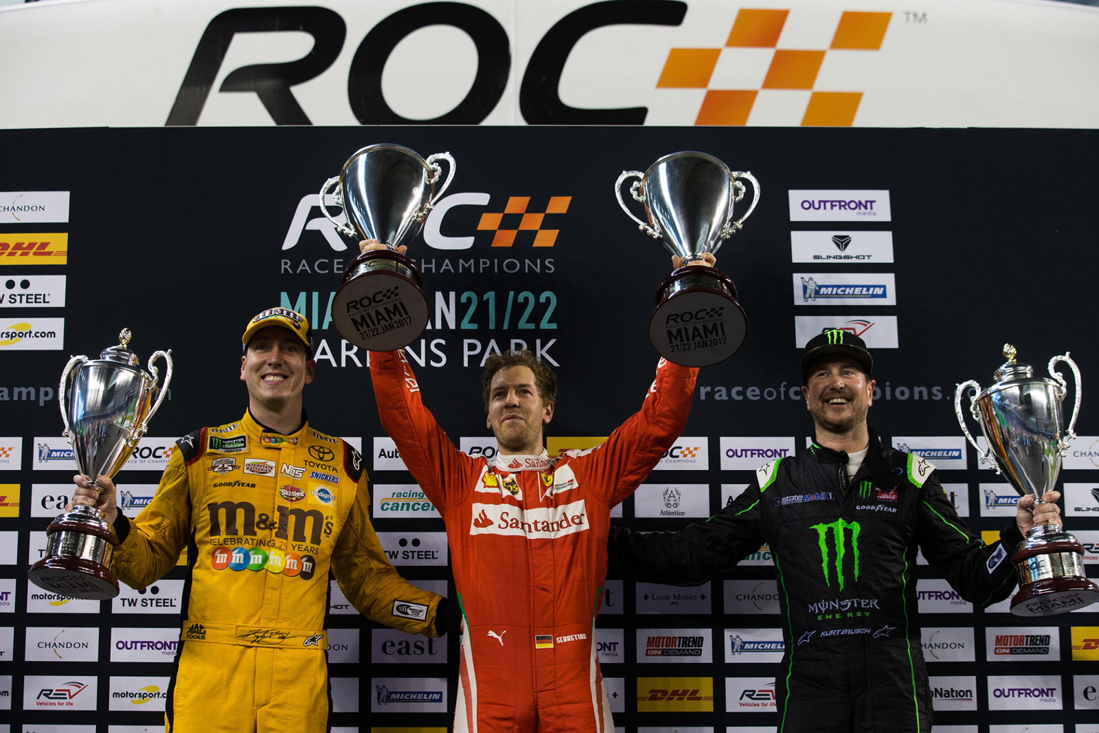 Team Germany's Sebastian Vettel celebrates winning with runners up Kurt Busch and Kyle Busch of Team USA during the ROC Nations Cup at Marlins Park in 2017.