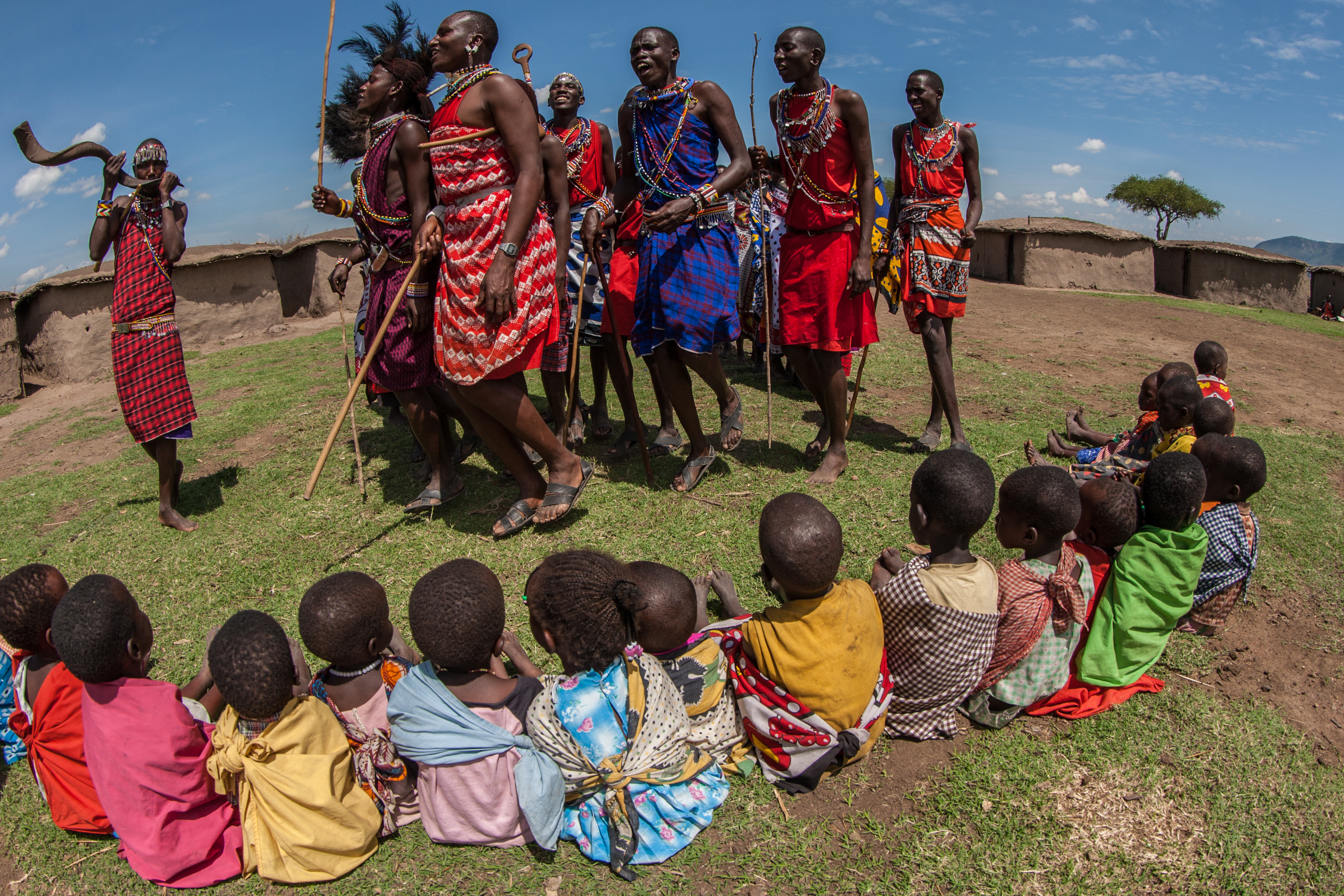 Photograph of Maasai Mara tribespeople in a village in the Maasai Mara, Kenya, Africa, taken by wildlife photographer and conservationist Angela Scott