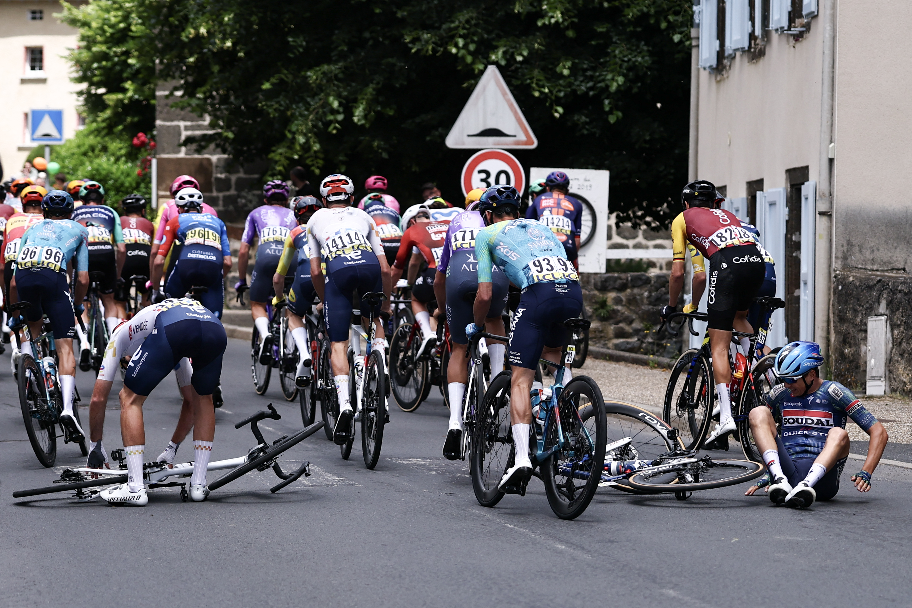 Soudal Quick-Step's Belgian rider Mauri Vansevenant and TotalEnergies's French rider Thibault Guernalec crash during the 4th stage of the Tour Auvergne-Rhone-Alpes cycling race (formerly known as the Criterium du Dauphine), 167,4km between Le Puy-en-Velay and Montrond-les-Bains, central France, on June 10, 2026. (Photo by Anne-Christine POUJOULAT / AFP via Getty Images)