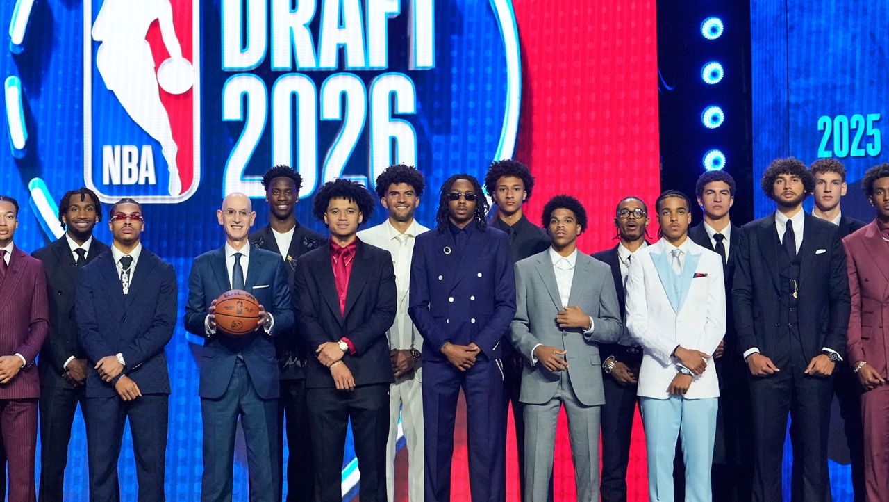 Prospective draftees pose for a group photo with NBA Commissioner Adam Silver, center, before the first round of the NBA basketball draft, Tuesday, June 23, 2026, in New York. (AP Photo/Yuki Iwamura)