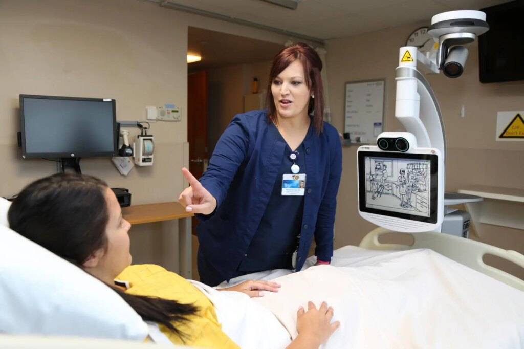 Nurse performs neurologic assessment on patient