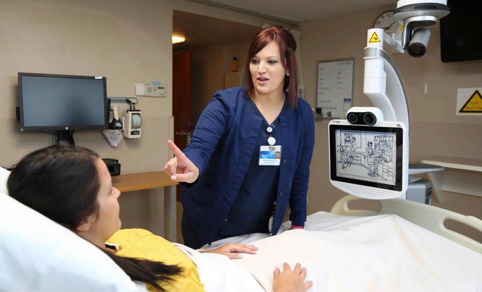 Nurse performs neurologic assessment on patient