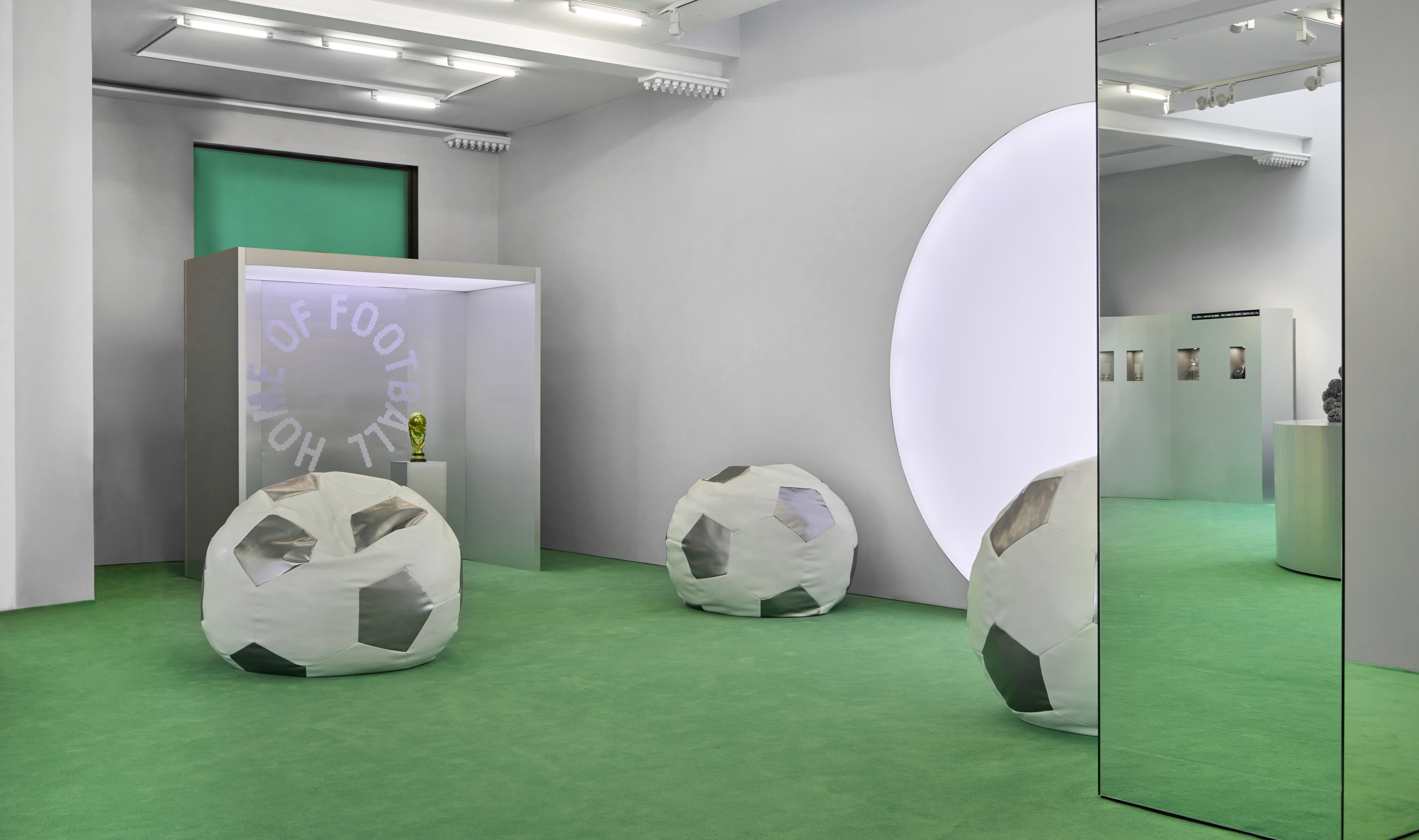 Inside Home of Football: Home &amp; Away exhibition with pitch-green flooring and ball-shaped beanbag seating