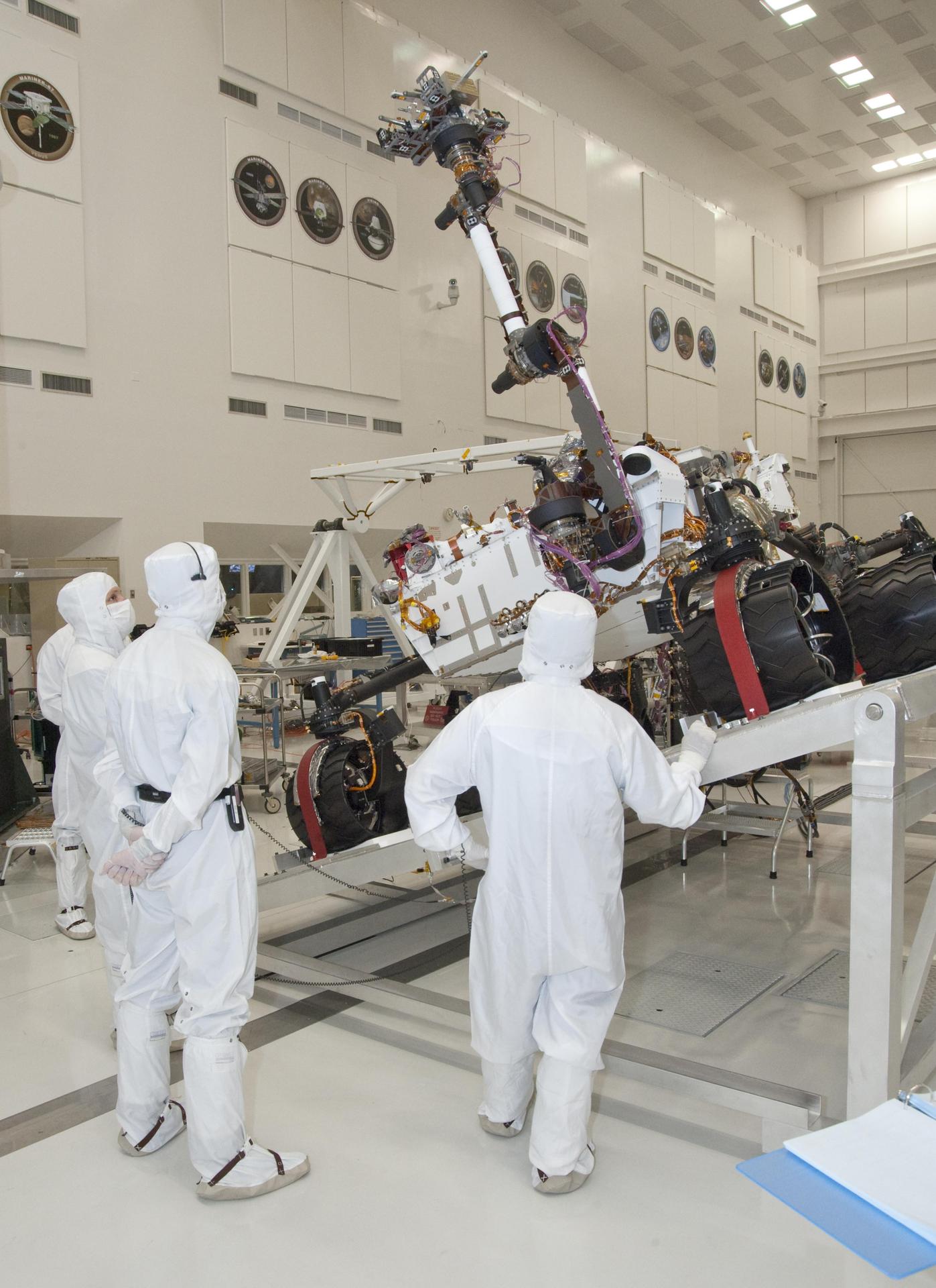 NASA Mars rover, Curiosity, stretches its robotic arm upward during tests on a tilt table in a clean room at NASA Jet Propulsion Labotatory.