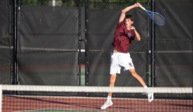The Patriots’ Brooks Miller delivers a return playing first doubles against Lexington on June 4. Photo by Alexis Guinebertiere