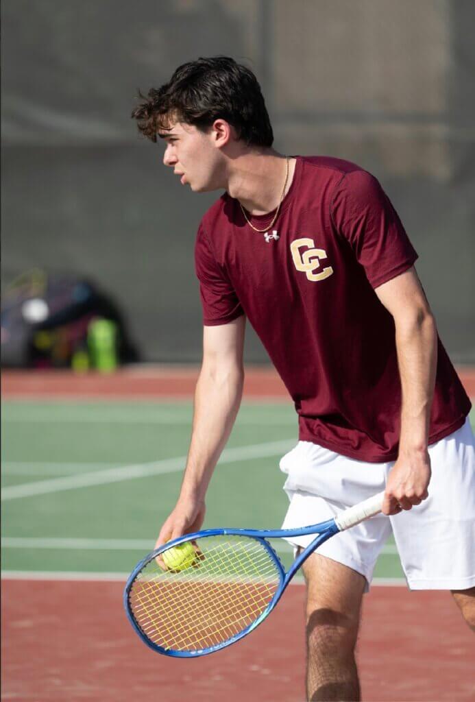 Concord-Carlisle’s Mack Rottenberg prepares to serve in his doubles match against Lexington on June 4. Photo by Alexis Guinebertiere