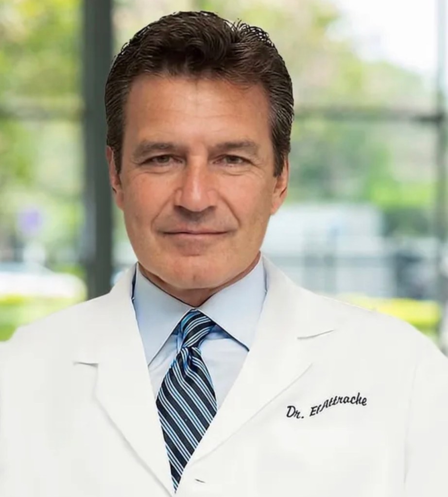 Dr. Neal ElAttrache in a white lab coat and tie.