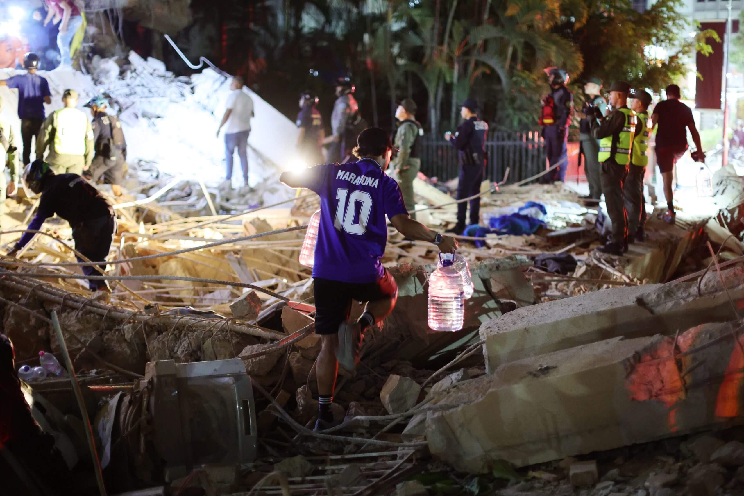 A man walks through the rubble in Venezuela.