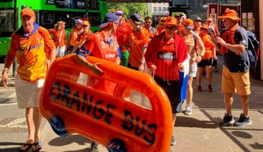 An orange bus dinghy leads march in Bristol for women's cricket