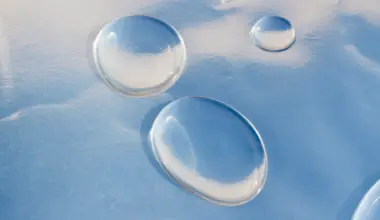Why water nanodrops spread thinner than expected