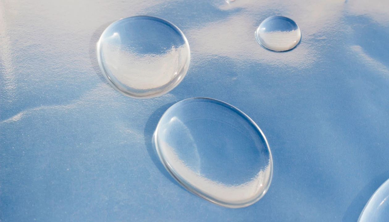 Why water nanodrops spread thinner than expected