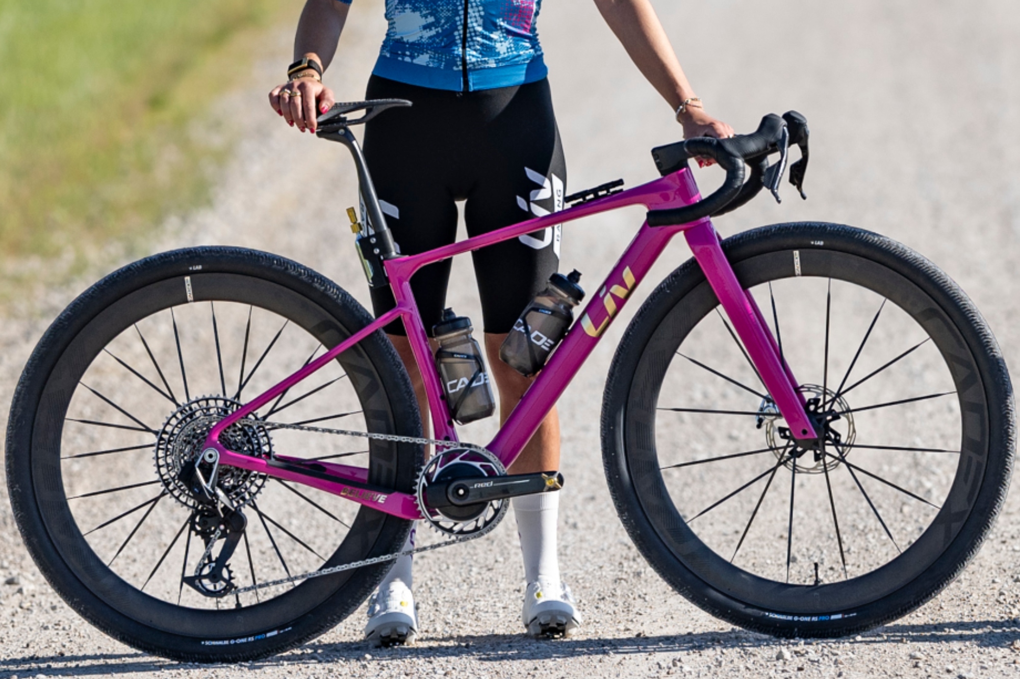 A rider stands behind the new Liv Revolt gravel bike