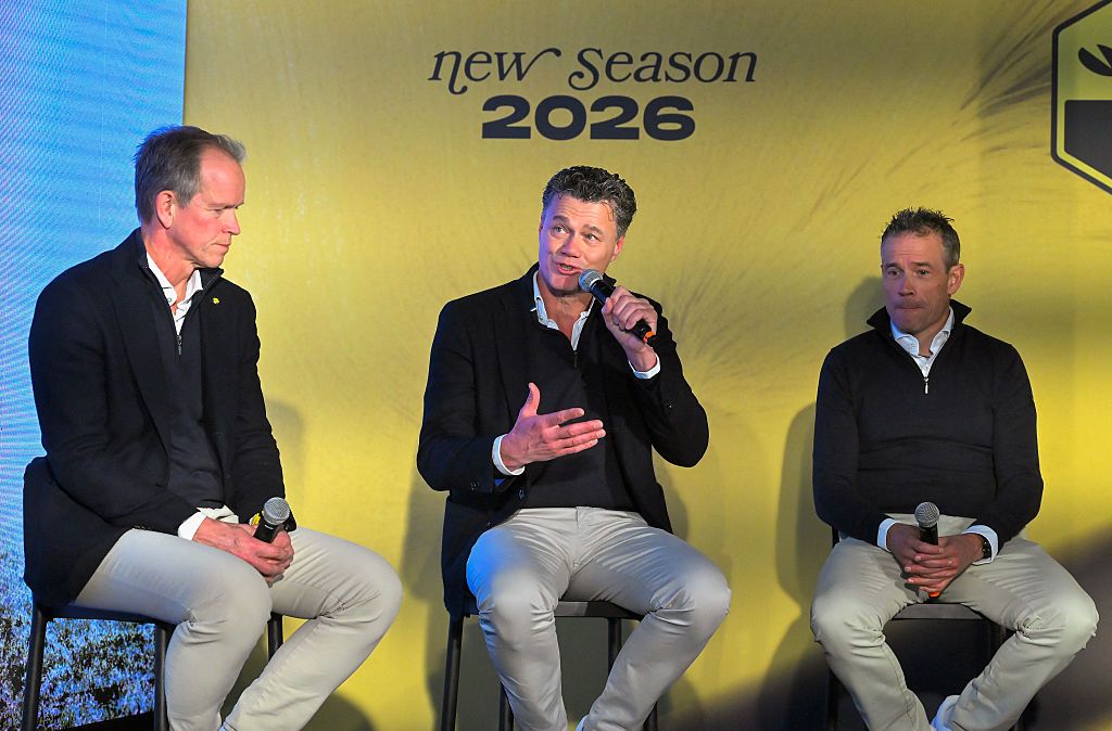 Visma-Lease a Bike's head of coaching Jacco Verhaeren (C) speaks next to Visma-Lease a Bike's Managing Director Richard Plugge of Netherlands (L) and head of racing Grischa Niermann of Germany during the presentation of the Visma-Lease a Bike cycling teams at La Nucia near Alicante, eastern Spain on January 13, 2026. (Photo by Jose Jordan / AFP)