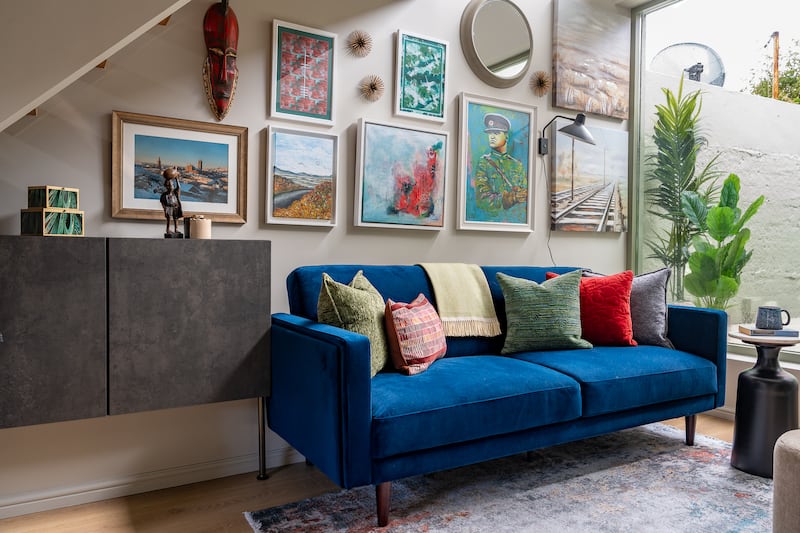 A gallery wall displays personal pieces from Irish artists related to the owner's hometown of Cork