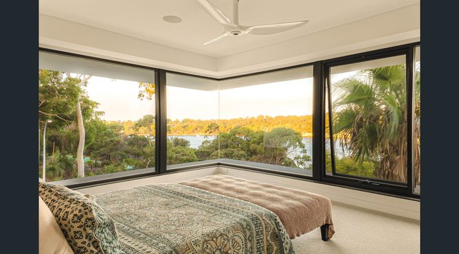 The property features light-filled open-plan living spaces with soaring ceilings.