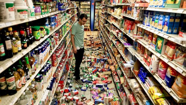 An owner of the Redwood Valley Market looks at the mess made during a earthquake in Redwood Valley, California.