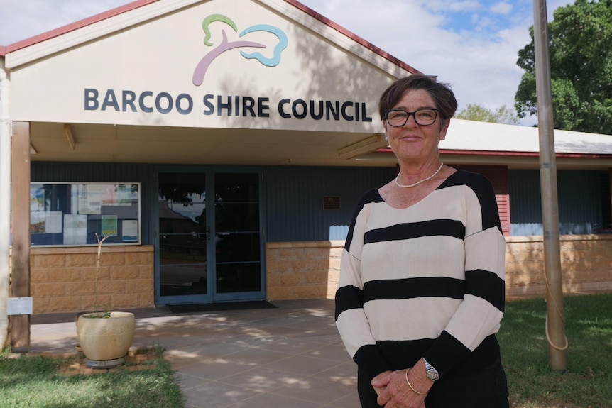 Woman in black and white shirt stands out the front of a council building.