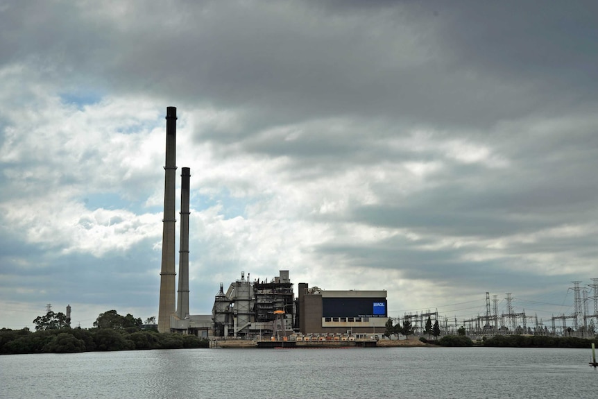 A power station on an island, as seen from across a waterway.