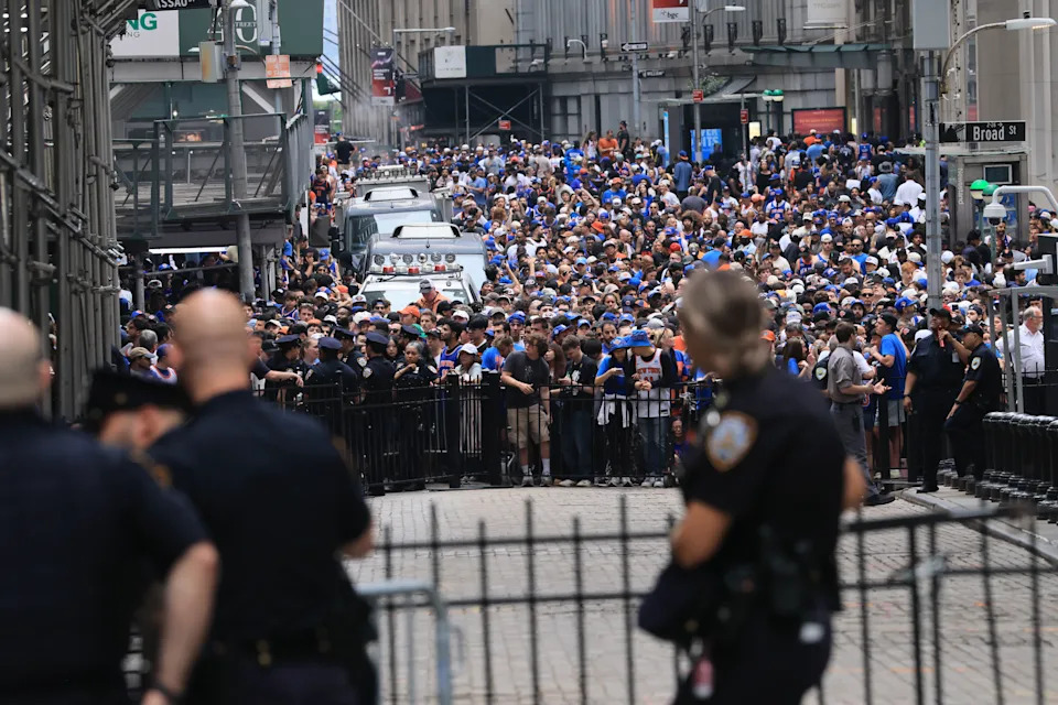 Thousands of fans crowd into lower Manhattan near Wall Street before the parade.