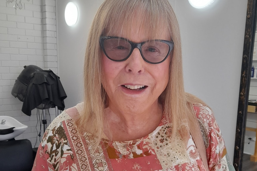 A woman looks at the camera